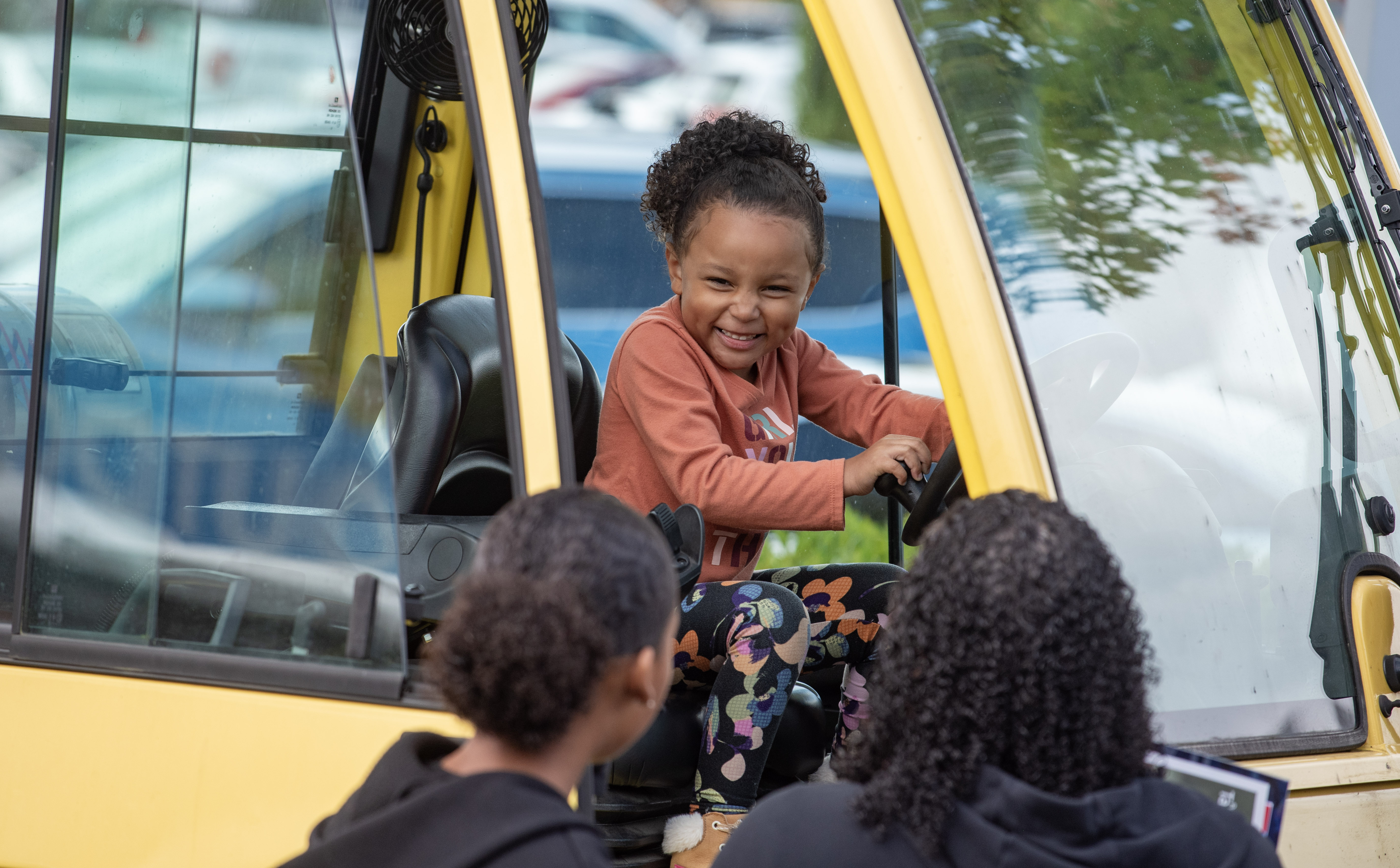 Smiling child in a truck.